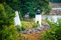 Whitlocks Mill Light Surrounded by Evergreens on Riverbank